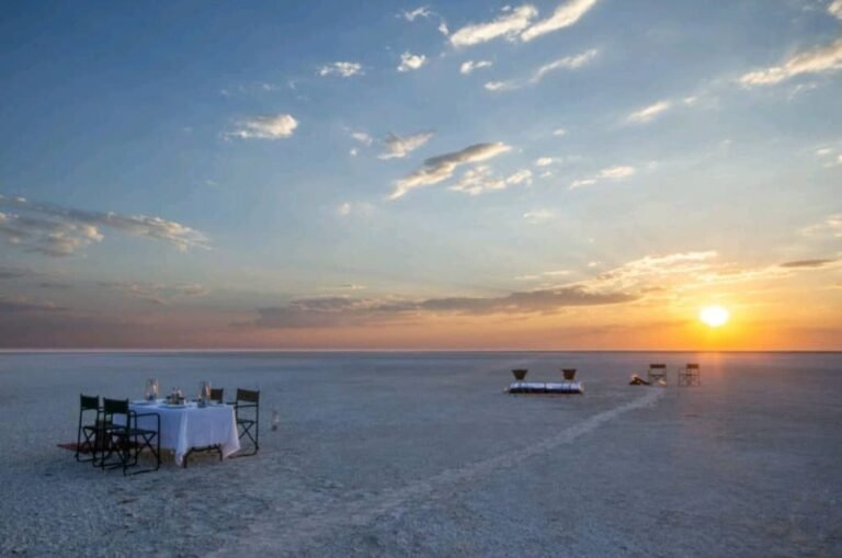 Dinner table set out on the white Makgadikgadi salt pans at sunset