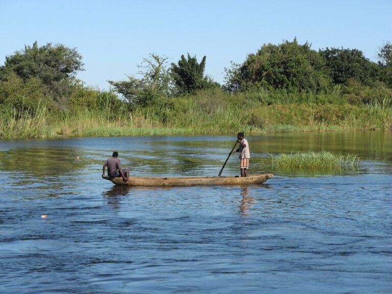Two local fishermen paddling a dugout canoe on the Zambezi