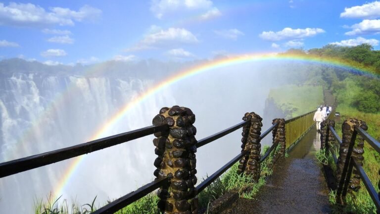 Rainbow arching over Victoria Falls in the spray